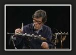 John Cage playing amplified cacti and plant materials with a feather